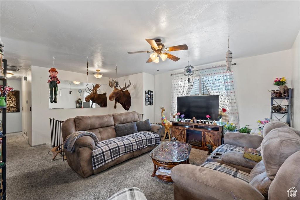 Carpeted living room with ceiling fan