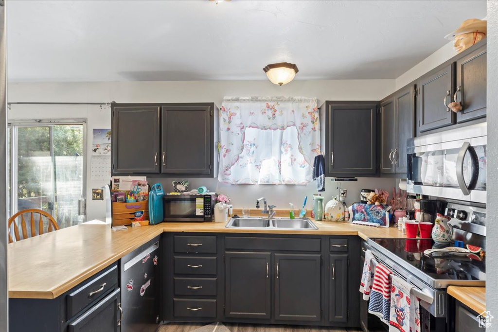 Kitchen featuring stainless steel appliances and a peninsula
