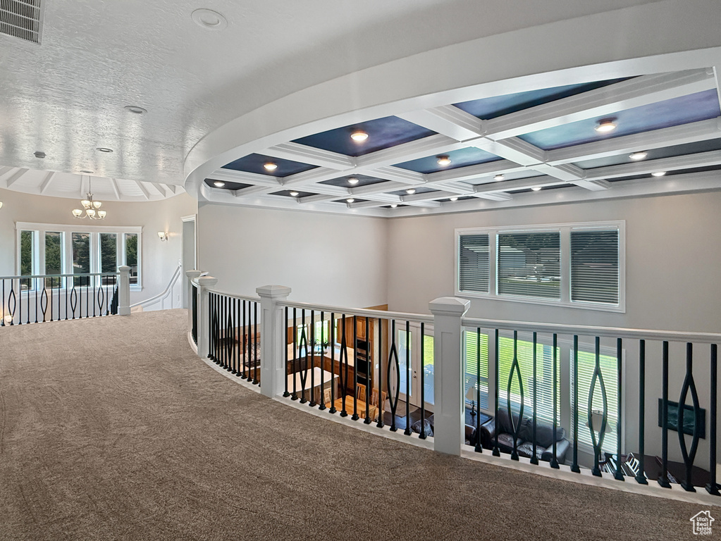 Hall featuring a chandelier, carpet flooring, coffered ceiling, beam ceiling, and recessed lighting
