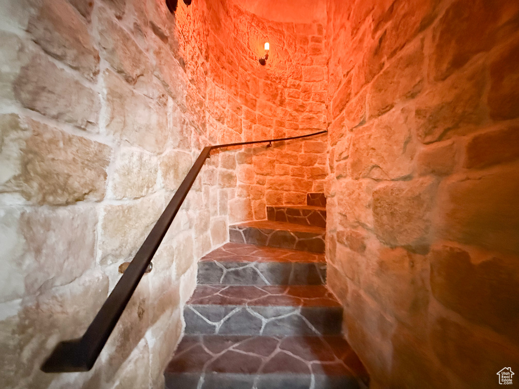 Stairway featuring stone flooring