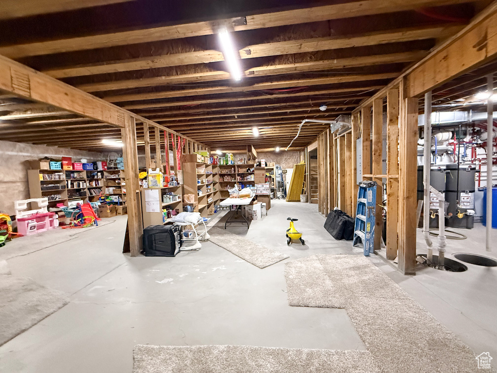 Unfinished basement featuring water heater