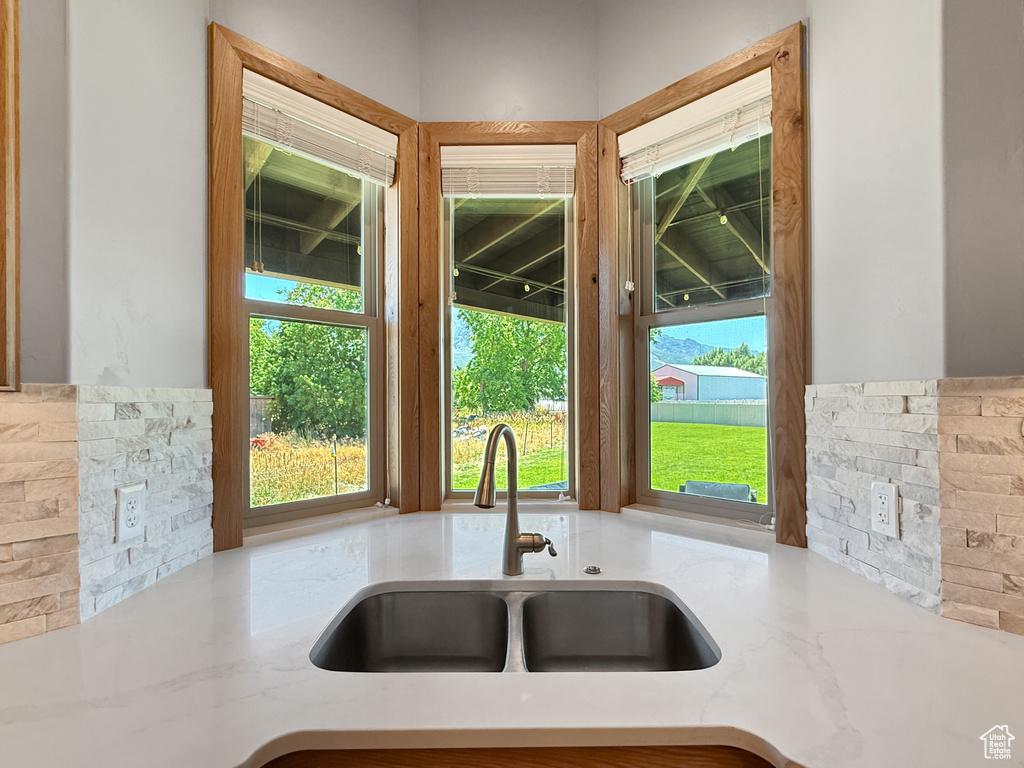 Kitchen with a sink and light stone countertops