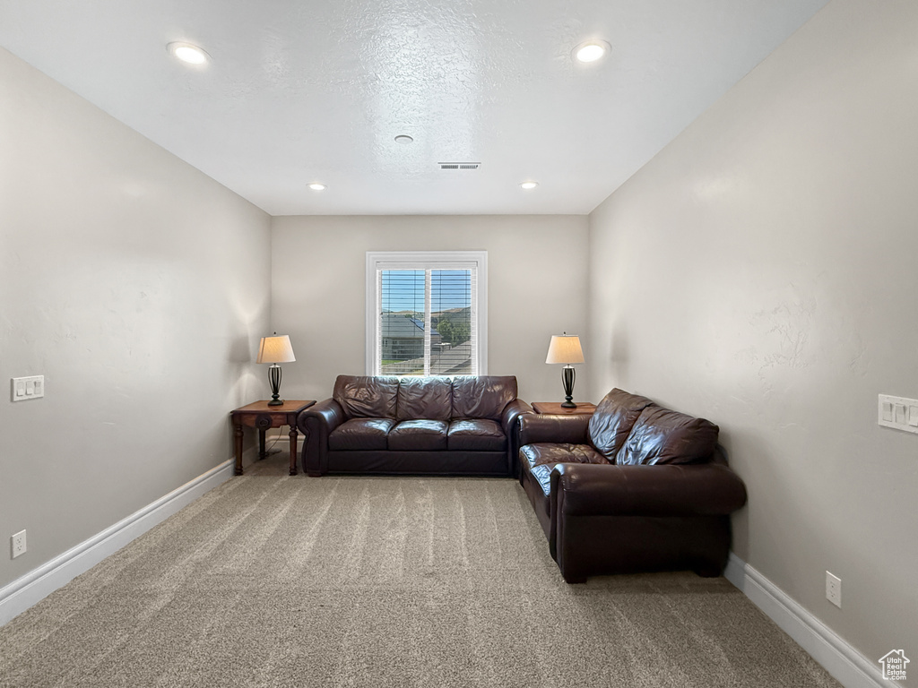 Carpeted living room featuring baseboards and recessed lighting