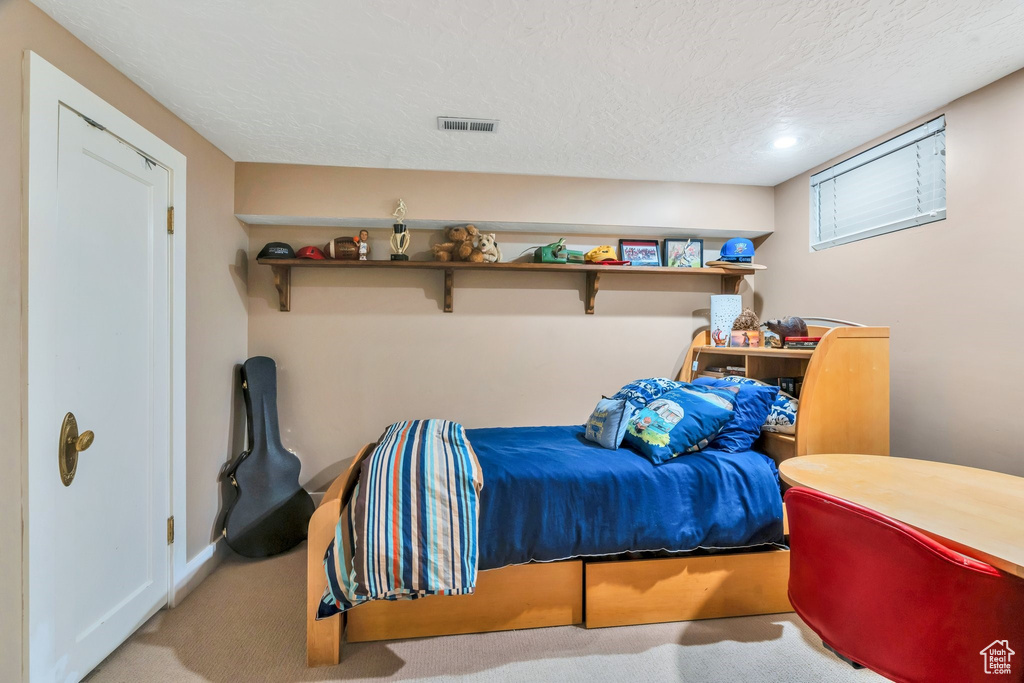 Bedroom featuring carpet flooring, a textured ceiling, and recessed lighting