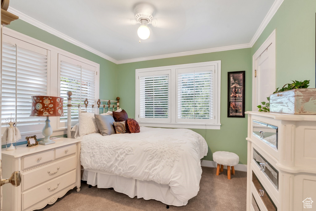 Bedroom featuring light colored carpet and crown molding