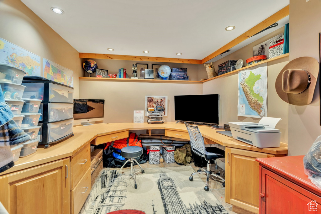 Office area with built in desk and recessed lighting