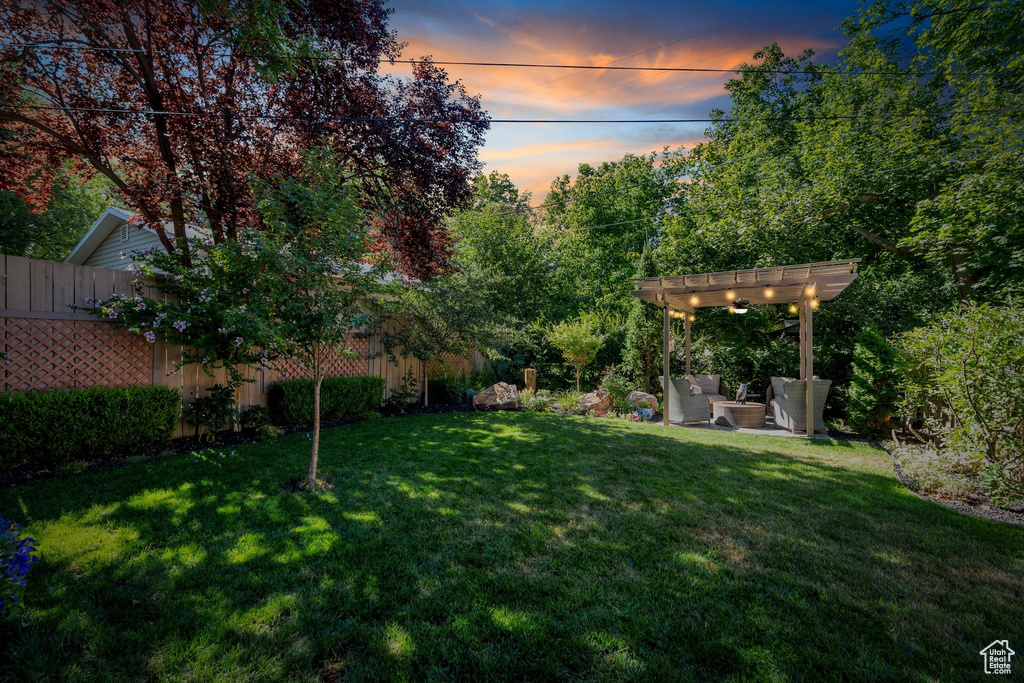 View of yard with a pergola, a patio area, and an outdoor hangout area