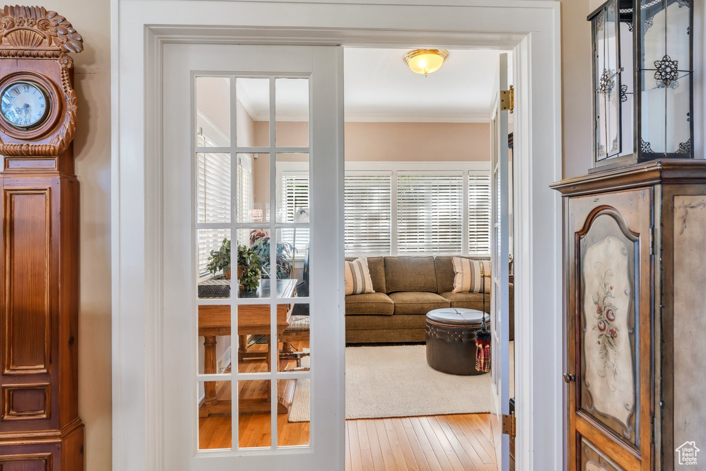 Sitting room featuring ornamental molding and wood-type flooring