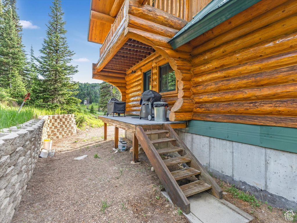 View of patio with a grill