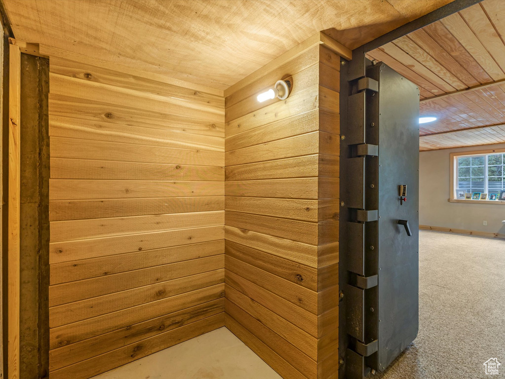 Relaxing sauna featuring wooden ceiling and carpet