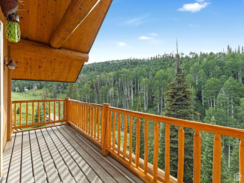 Wooden deck featuring a wooded view