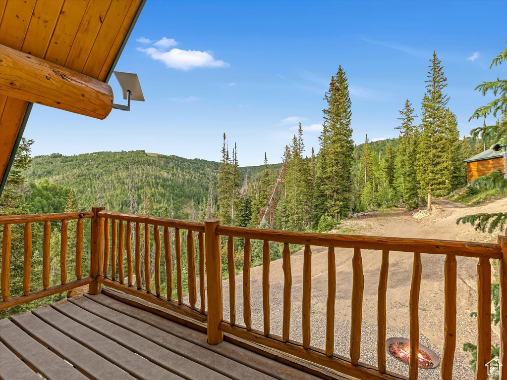 Deck with a forest view and a mountain view