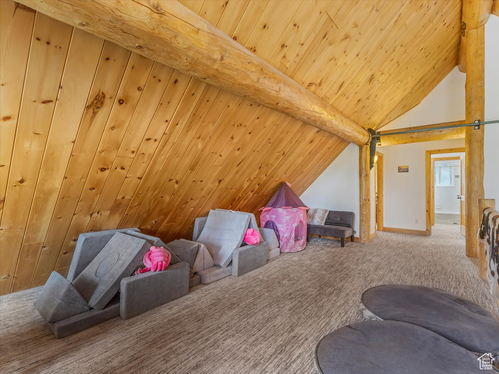 Additional living space featuring carpet floors and wooden ceiling