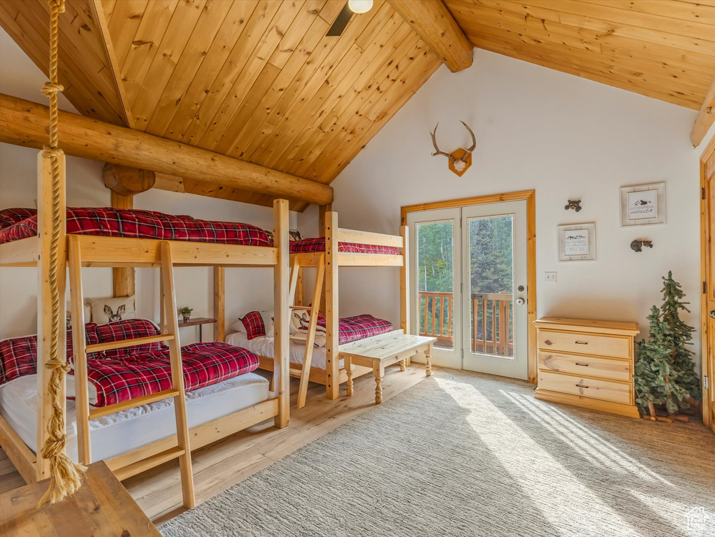 Bedroom with access to outside, wooden ceiling, and wood finished floors