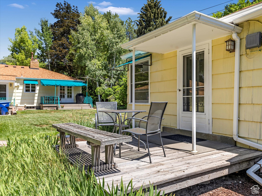 Deck featuring a lawn and outdoor dining space