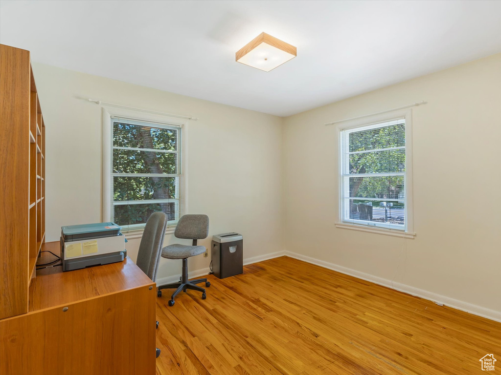 Office with light wood-style floors and baseboards