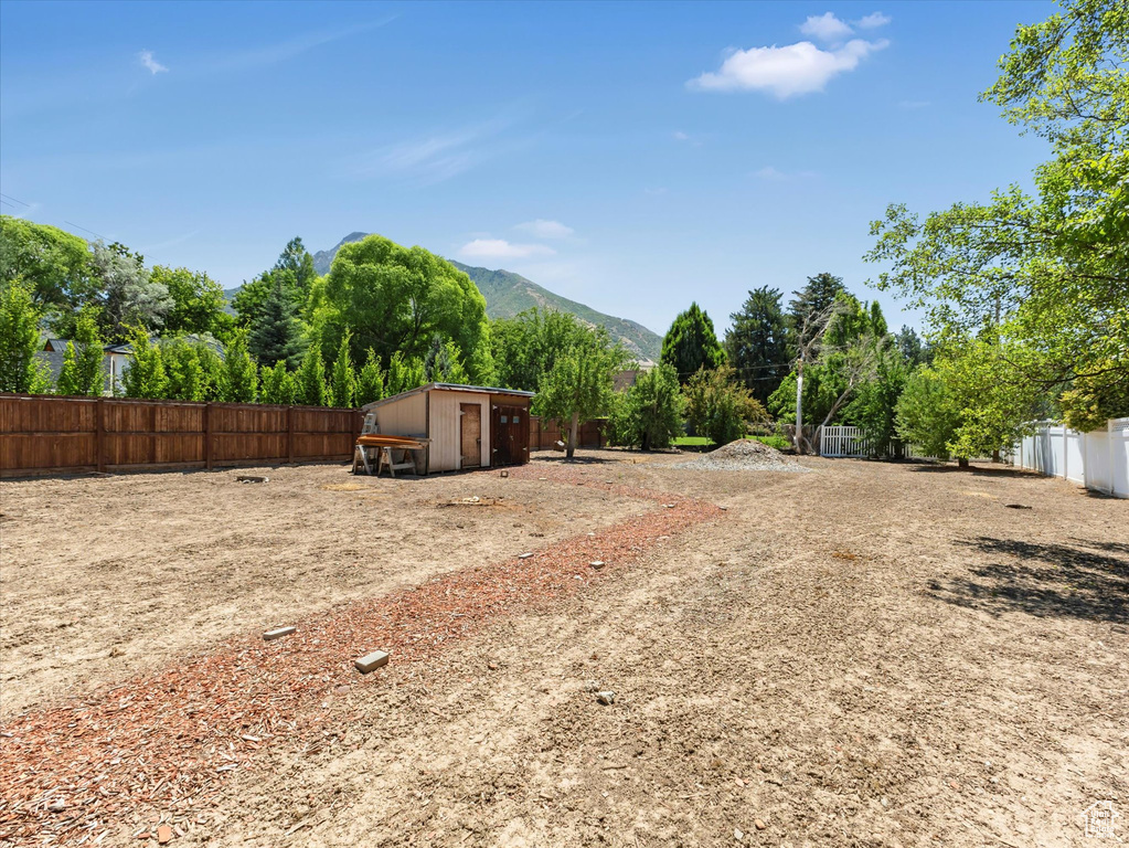 View of yard with a mountain view and an outdoor structure