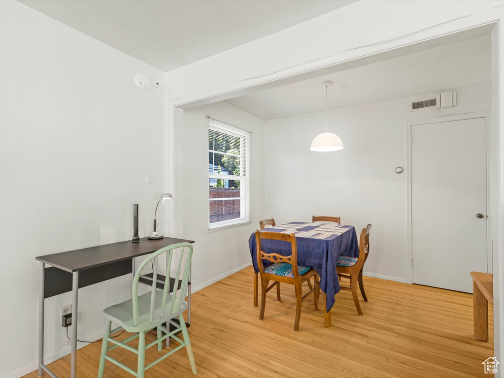 Dining room with light wood-style floors and baseboards
