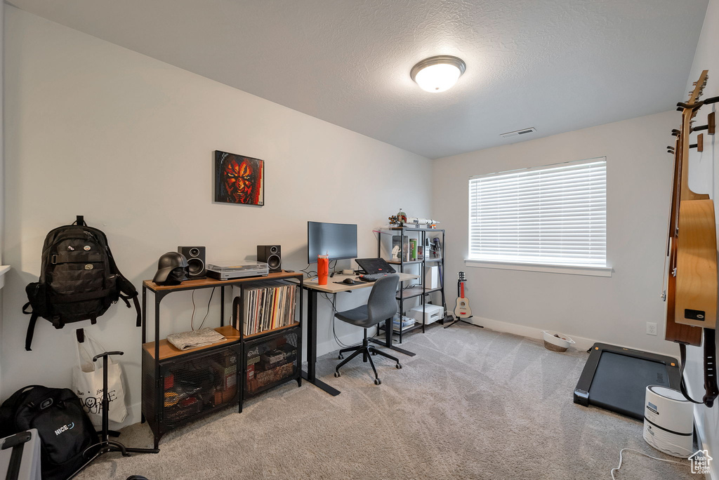 Carpeted office space featuring baseboards