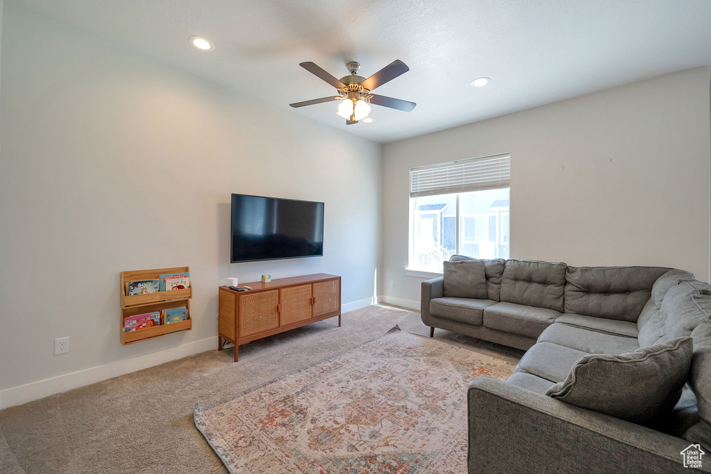Living area featuring carpet, a ceiling fan, and recessed lighting