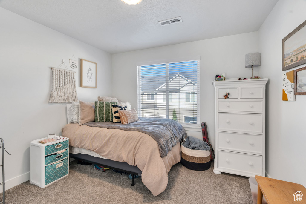 Carpeted bedroom with baseboards