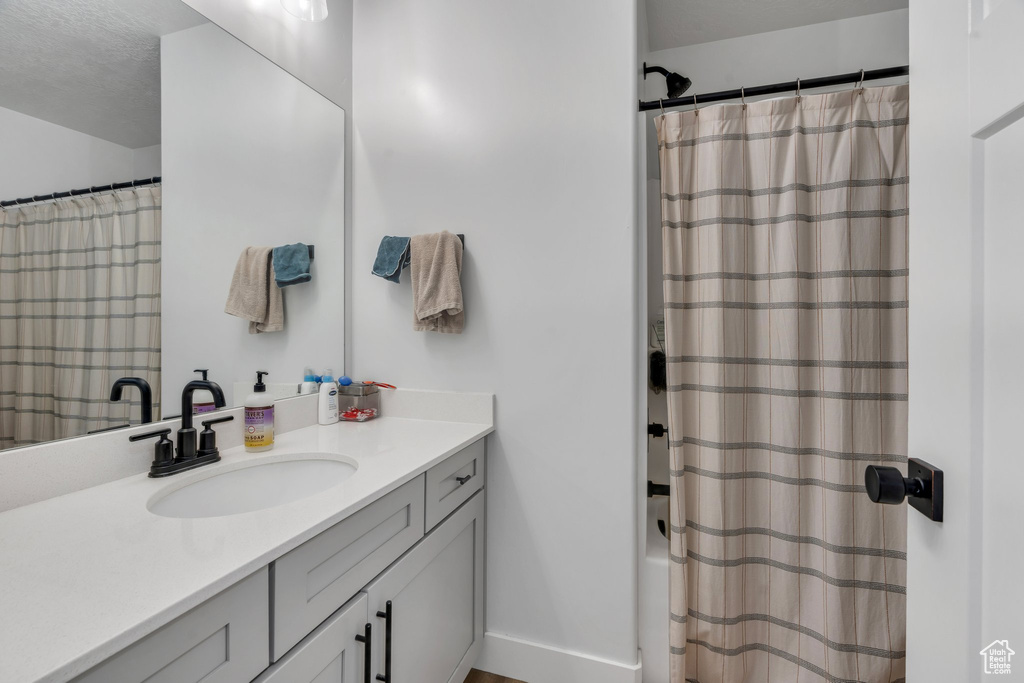 Full bath featuring vanity and a shower with curtain