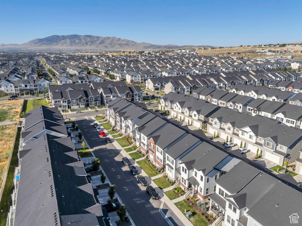 Aerial overview of property's location with nearby suburban area and a mountainous background