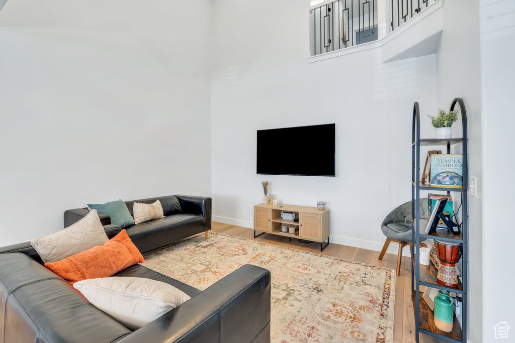 Living area with wood finished floors and baseboards