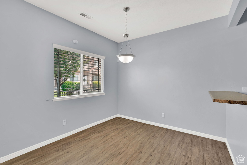 Empty room with wood finished floors and baseboards