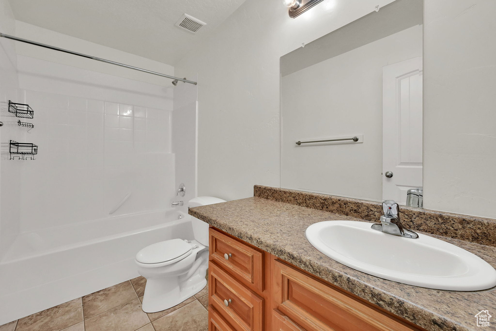 Full bath with vanity, bathtub / shower combination, and tile patterned flooring