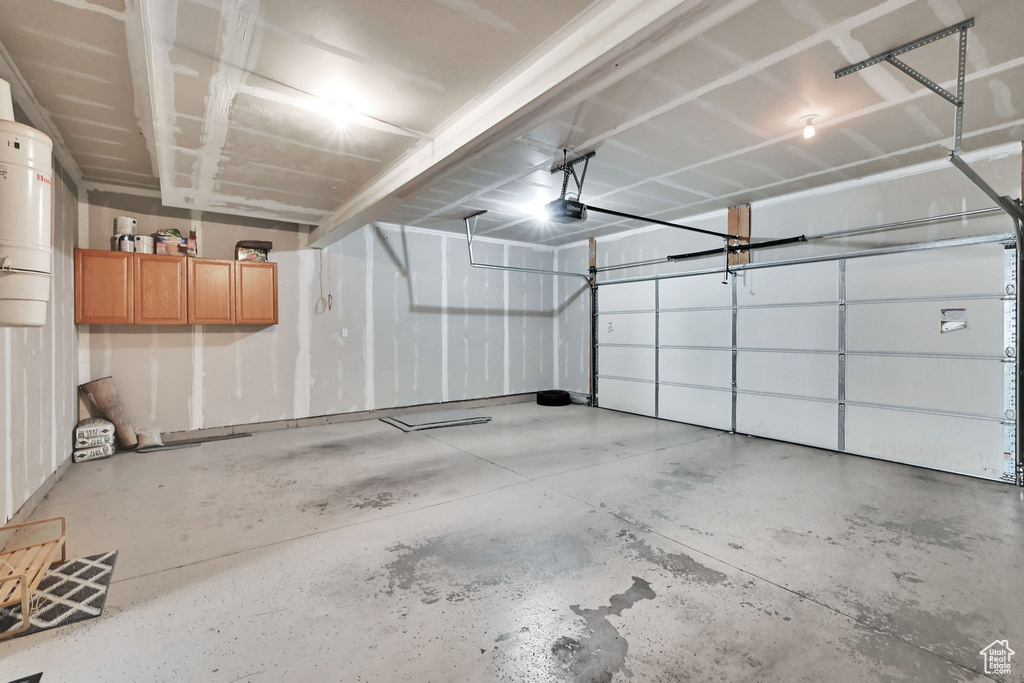 Garage with a central vacuum unit and a garage door opener