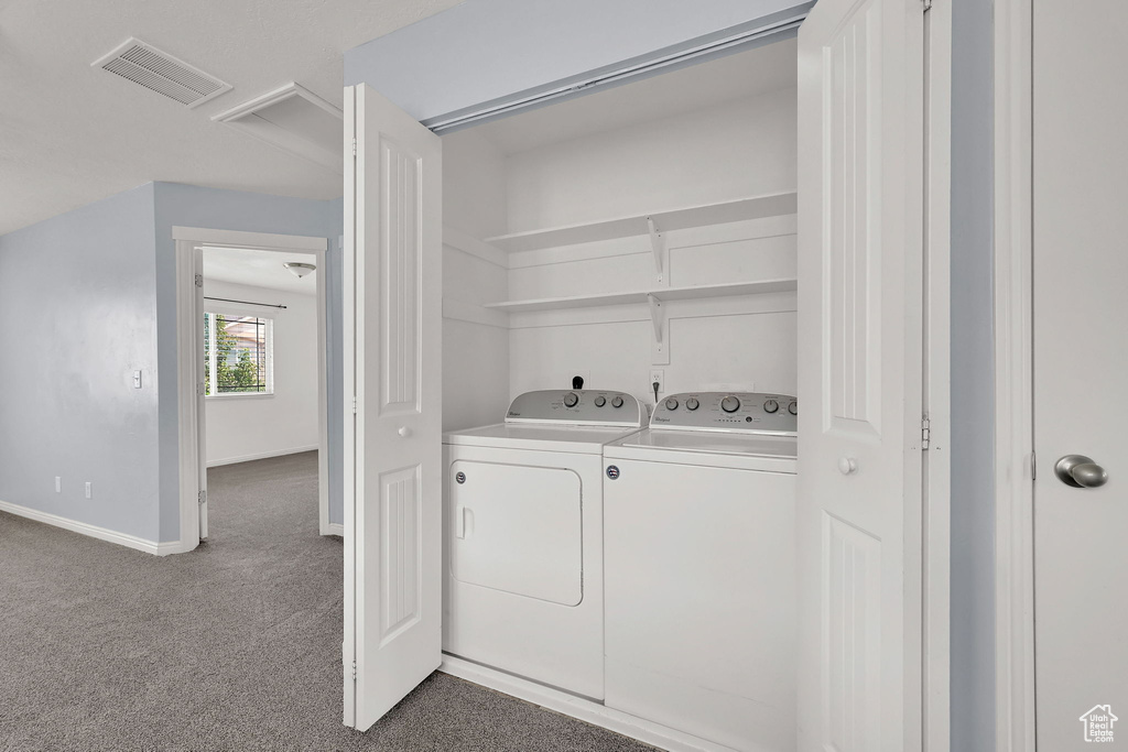 Laundry room featuring separate washer and dryer and carpet floors