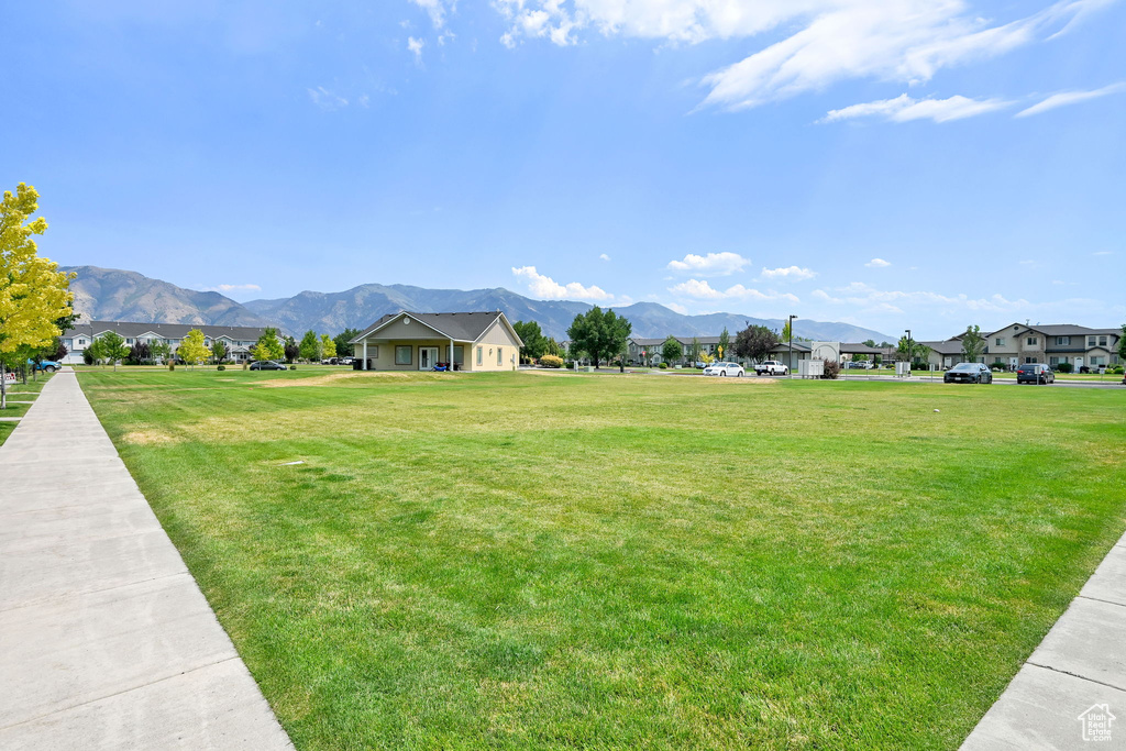 View of community featuring a mountain view, a residential view, and a yard