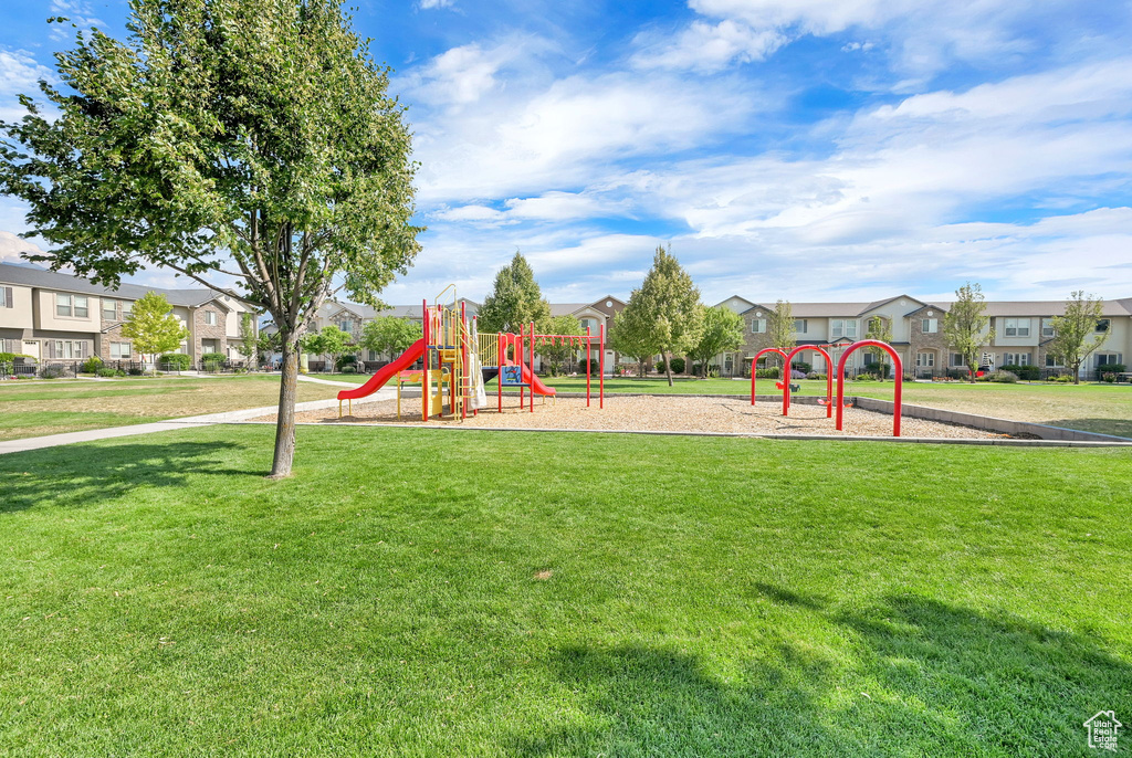 Community playground with a residential view and a lawn