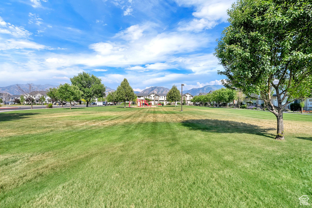 View of community with a mountain view and a yard