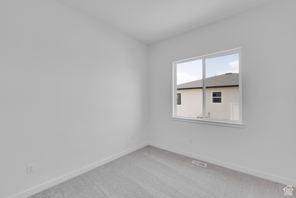 Unfurnished room with baseboards and carpet