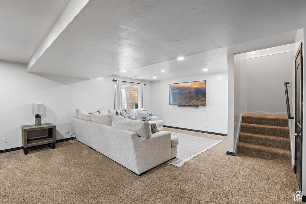 Living room with recessed lighting, carpet, and stairway