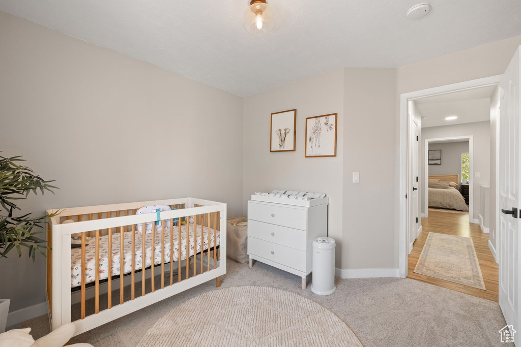 Bedroom featuring baseboards and carpet