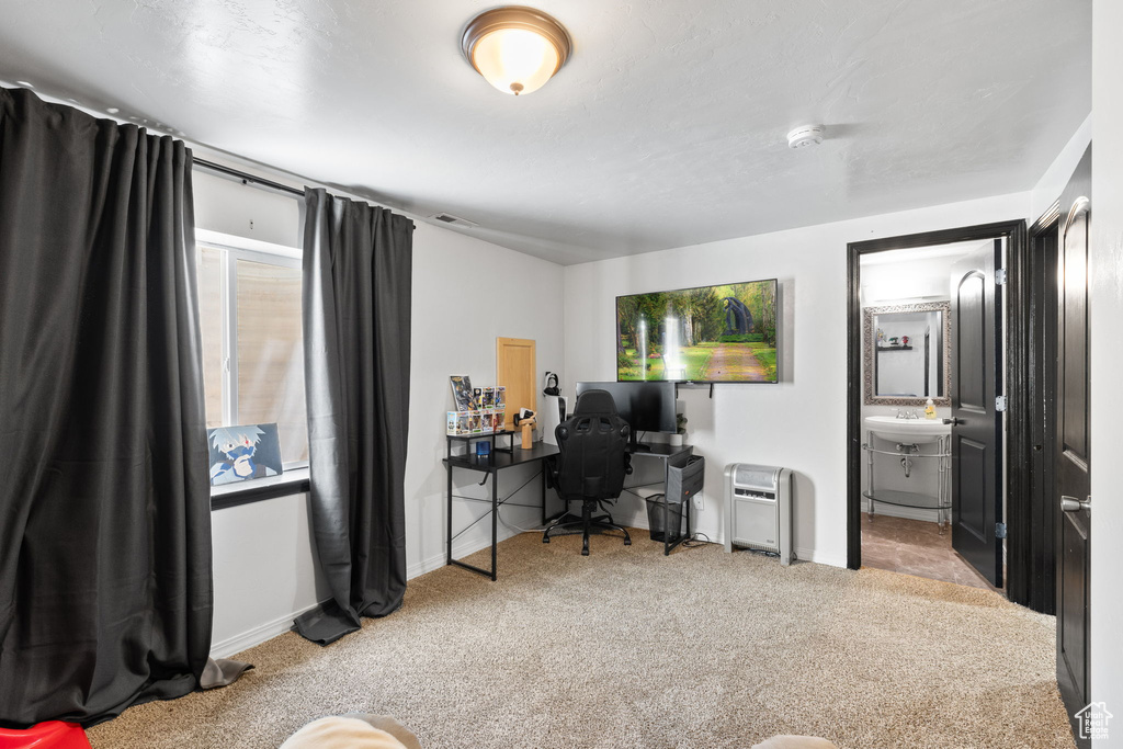 Carpeted office space with baseboards