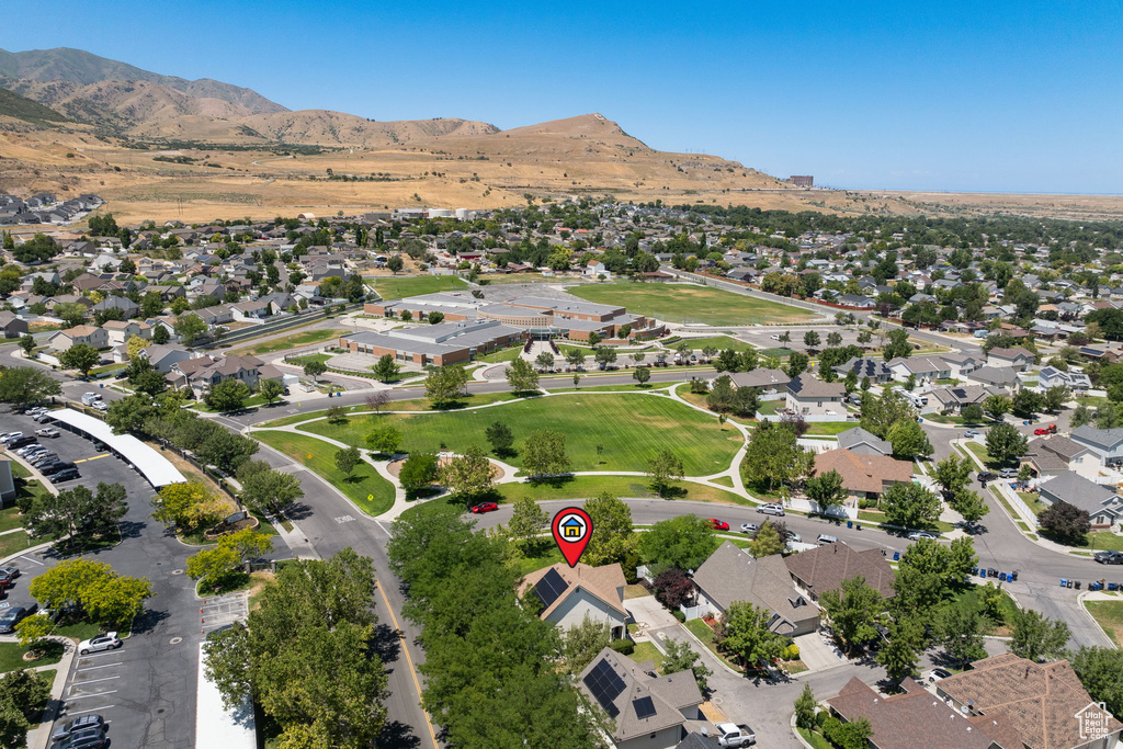 Aerial view of property\'s location featuring nearby suburban area and mountains