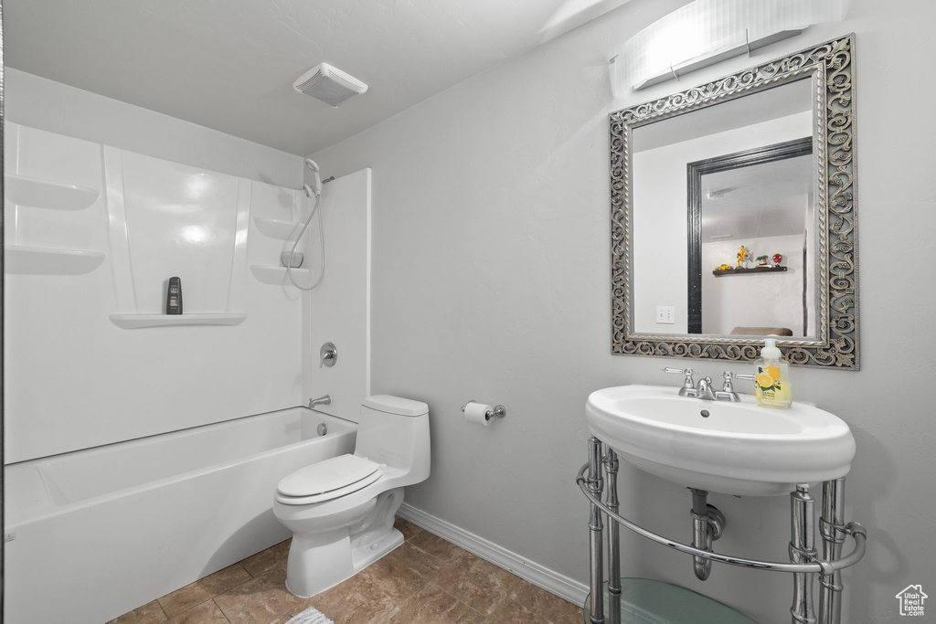 Bathroom featuring baseboards and  shower combination