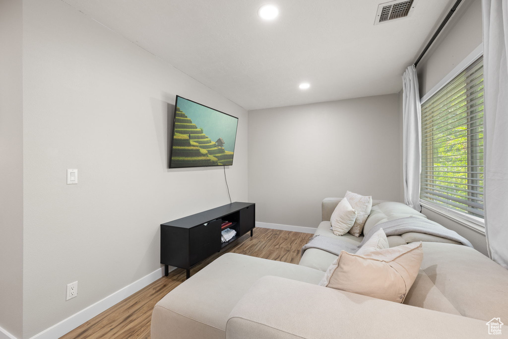 Living area featuring wood finished floors, recessed lighting, and plenty of natural light