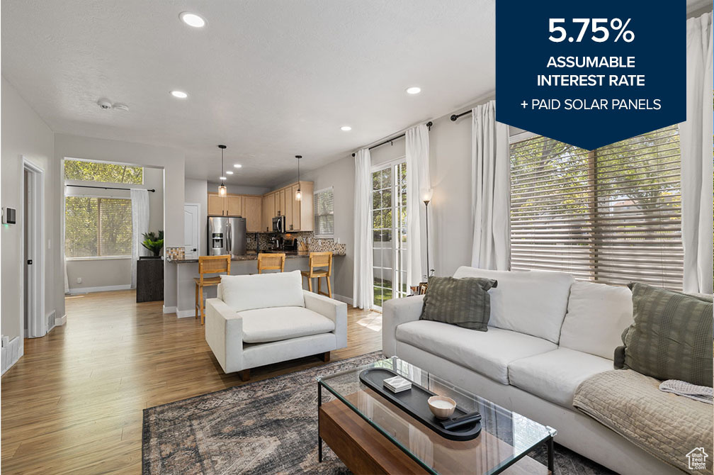 Living area with light wood-style floors and recessed lighting