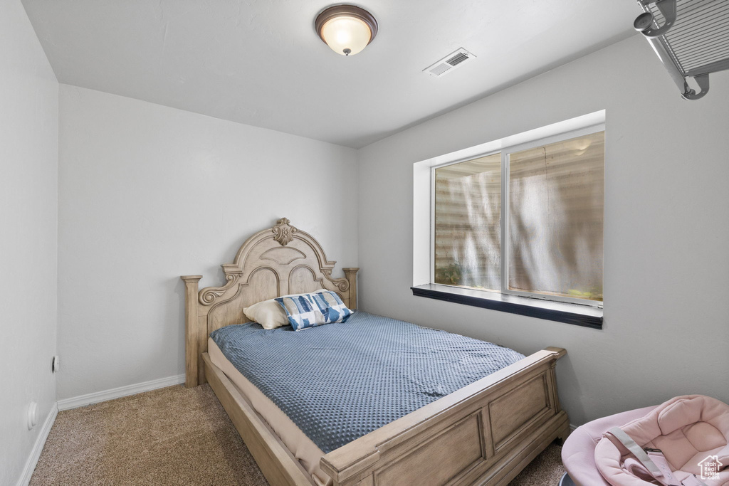 Bedroom with carpet floors and baseboards