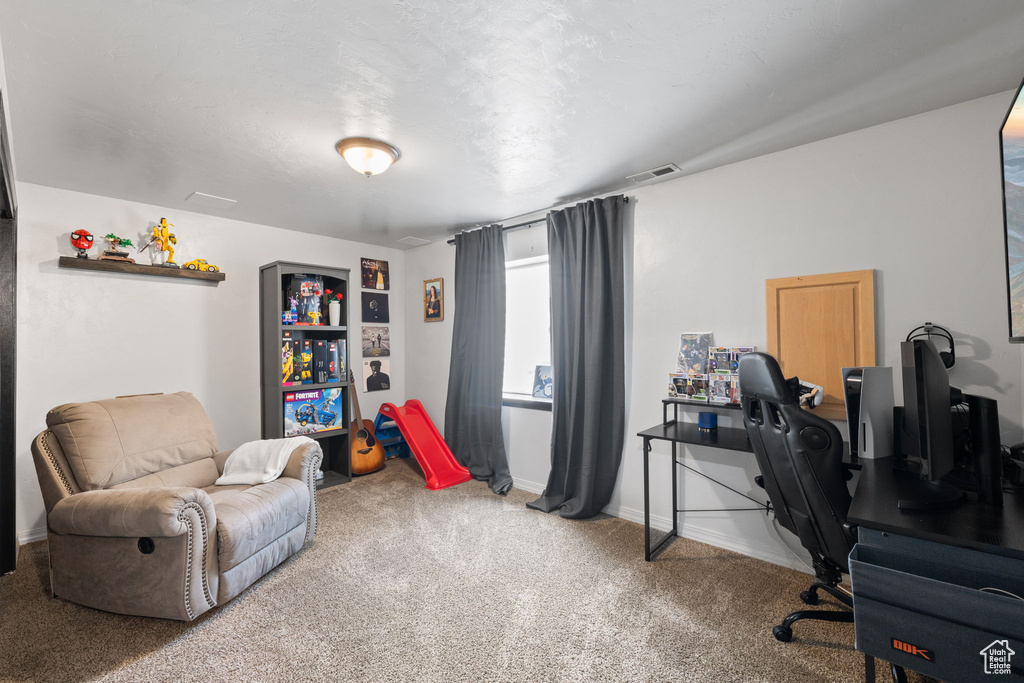 Home office featuring carpet flooring and baseboards