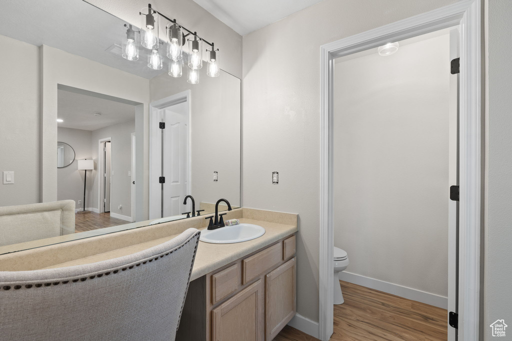 Bathroom featuring vanity and wood finished floors
