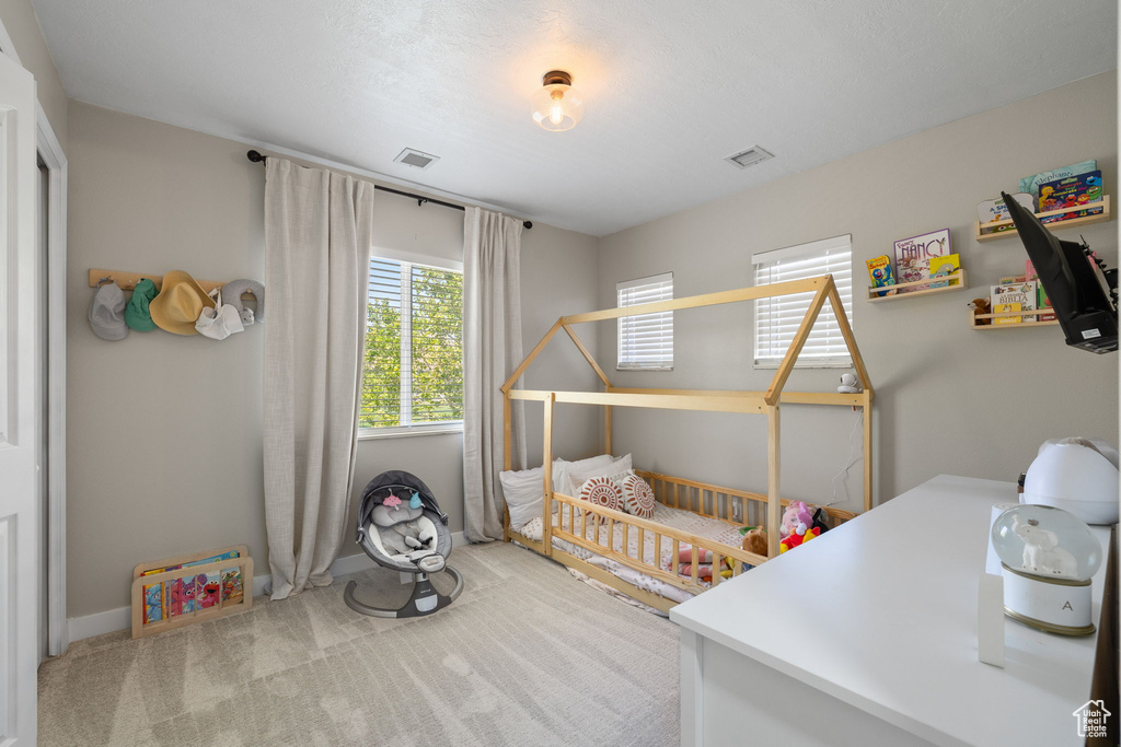 Carpeted bedroom featuring baseboards