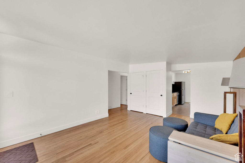 Living area with light wood-style flooring and baseboards