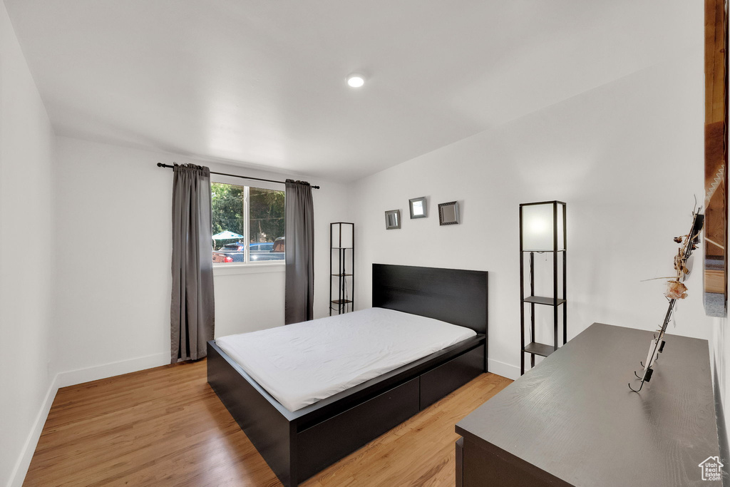 Bedroom with light wood-style flooring and recessed lighting