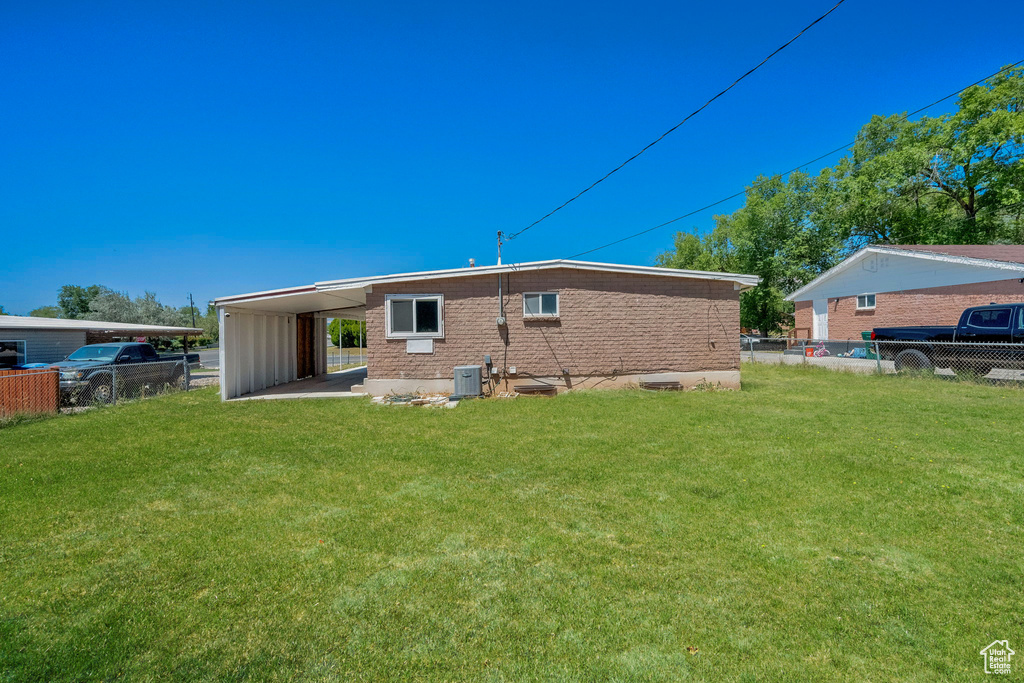 Rear view of property featuring a carport